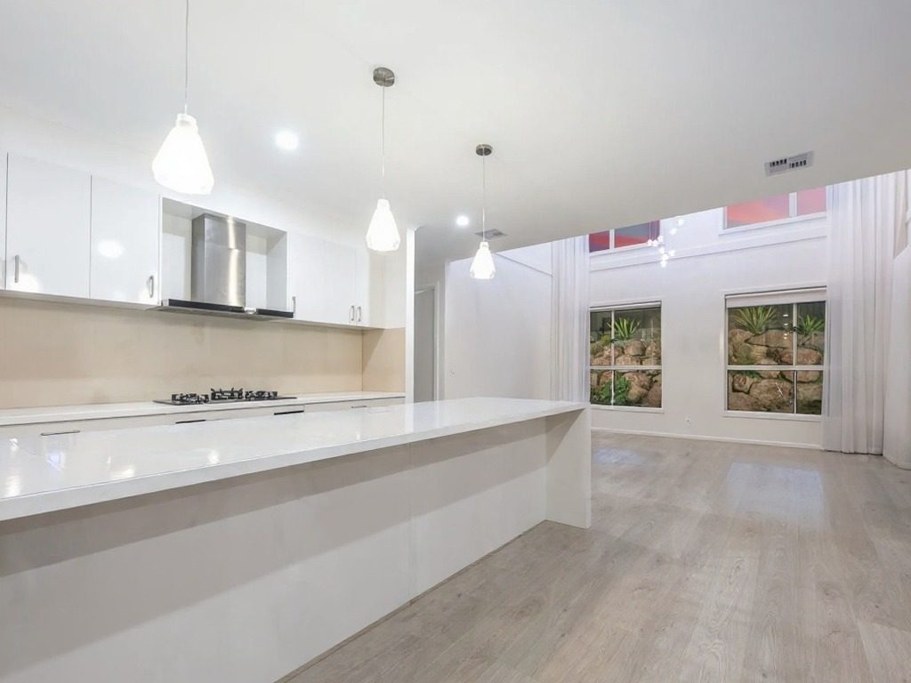 Modern kitchen with freshly painted walls and clean island bench in Aintree