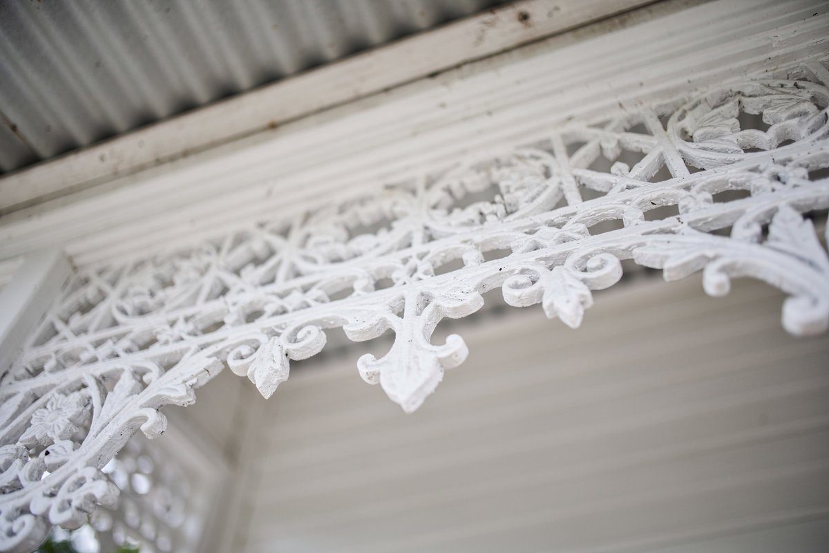 Close-up of painted verandah fretwork and trim detail on a Footscray weatherboard home