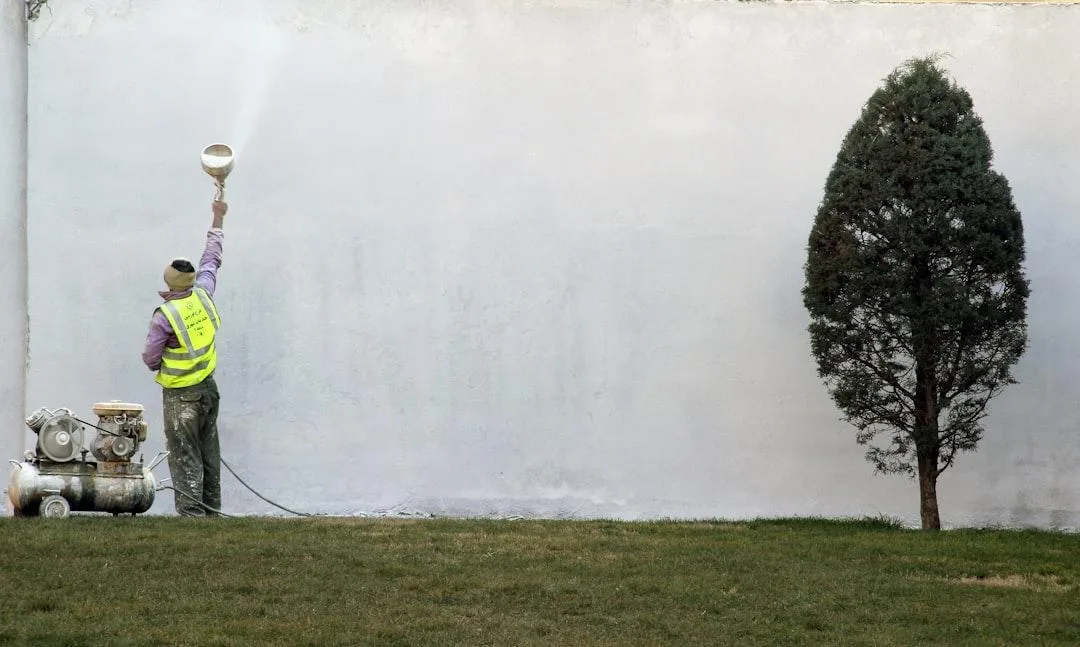 Professional painter spray painting exterior wall Melbourne